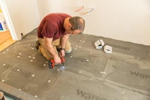 man doing underfloor insulation